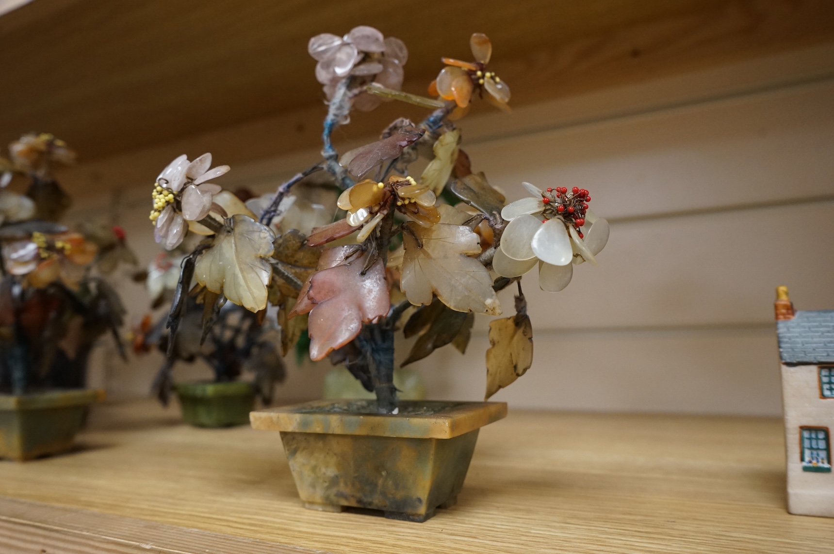 A collection of four ornamental Chinese hardstone flowering trees, tallest 22cm.